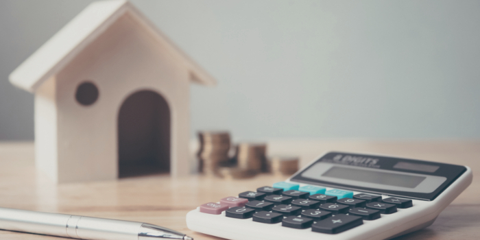 Close-up of remortgage calculator and house